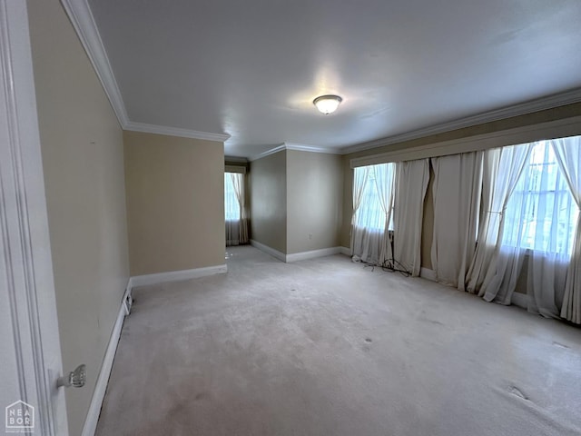 582 N 4th Ave, Piggott, AR 72454 - spare room featuring ornamental molding, baseboards, and light carpet