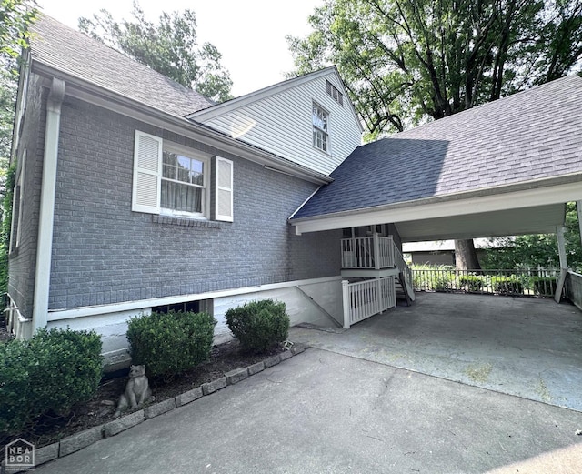 582 N 4th Ave, Piggott, AR 72454 - view of side of home featuring brick siding, driveway, and a shingled roof