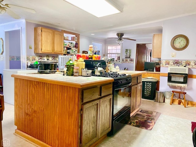 3601 Palestine Rd, Warm Springs, AR 72478 - kitchen with ceiling fan, black range with gas cooktop, tile countertops, heating unit, and ornamental molding