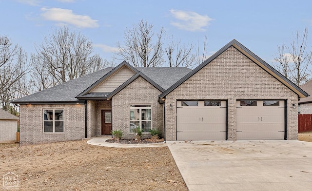 view of front of house featuring a shingled roof, brick siding, driveway, and an attached garage