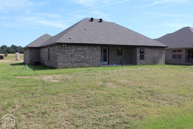 1805 Covey Dr, Jonesboro, AR 72404 - rear view of property featuring roof with shingles, a lawn, and brick siding