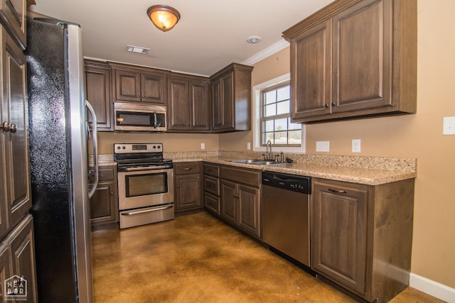1805 Covey Dr, Jonesboro, AR 72404 - kitchen with appliances with stainless steel finishes, finished concrete floors, dark brown cabinets, and crown molding