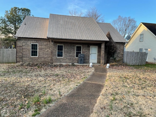 1805 Covey Dr, Jonesboro, AR 72404 - view of front of home with brick siding and a metal roof