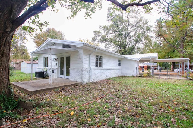 1805 Covey Dr, Jonesboro, AR 72404 - rear view of house with french doors, brick siding, and a carport