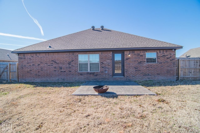 1805 Covey Dr, Jonesboro, AR 72404 - rear view of property featuring a fenced backyard, a patio, a shingled roof, and brick siding