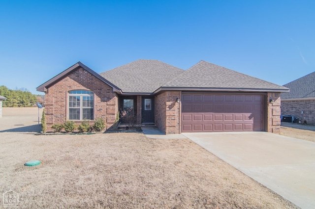 1805 Covey Dr, Jonesboro, AR 72404 - view of front of home featuring brick siding, an attached garage, driveway, and roof with shingles