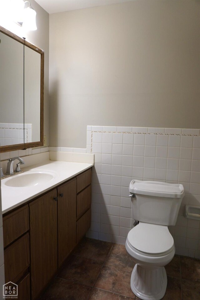 1805 Covey Dr, Jonesboro, AR 72404 - bathroom featuring vanity, tile walls, and a wainscoted wall