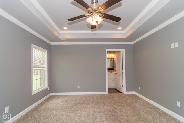 1805 Covey Dr, Jonesboro, AR 72404 - unfurnished bedroom featuring a raised ceiling, carpet flooring, ornamental molding, ensuite bathroom, and a ceiling fan