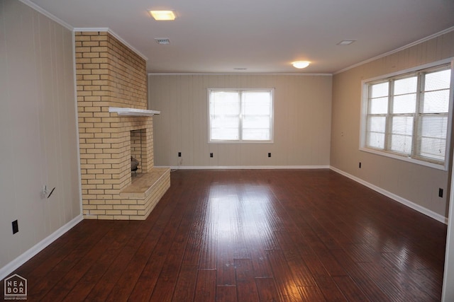 1805 Covey Dr, Jonesboro, AR 72404 - unfurnished living room with dark wood-type flooring, plenty of natural light, a brick fireplace, and crown molding