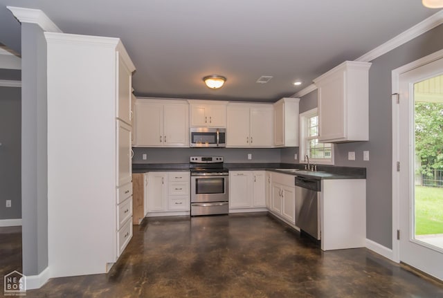 1805 Covey Dr, Jonesboro, AR 72404 - kitchen with appliances with stainless steel finishes, finished concrete floors, healthy amount of natural light, crown molding, and recessed lighting