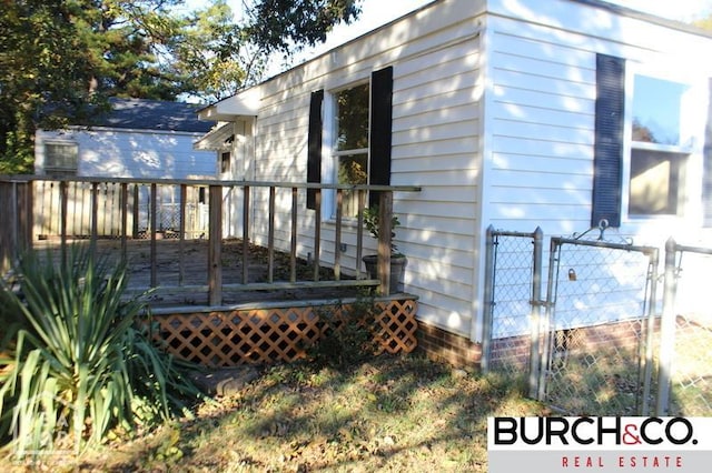 1805 Covey Dr, Jonesboro, AR 72404 - view of home's exterior with a wooden deck and a gate
