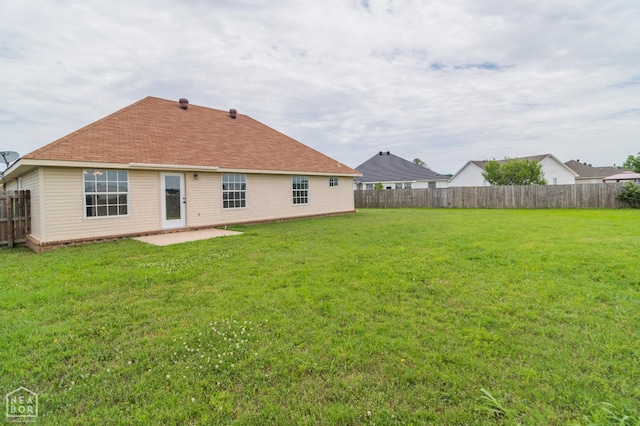 1805 Covey Dr, Jonesboro, AR 72404 - back of house with a fenced backyard, a patio area, and roof with shingles