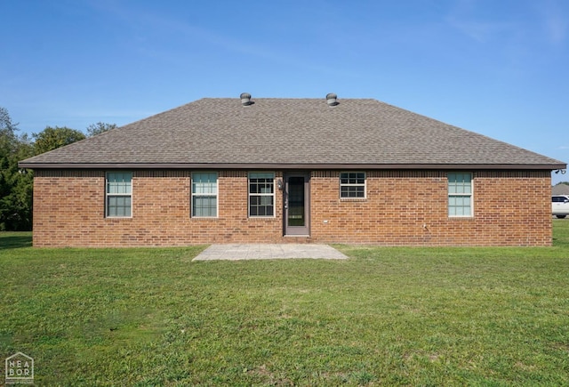 1805 Covey Dr, Jonesboro, AR 72404 - rear view of property featuring a patio, a shingled roof, and a lawn