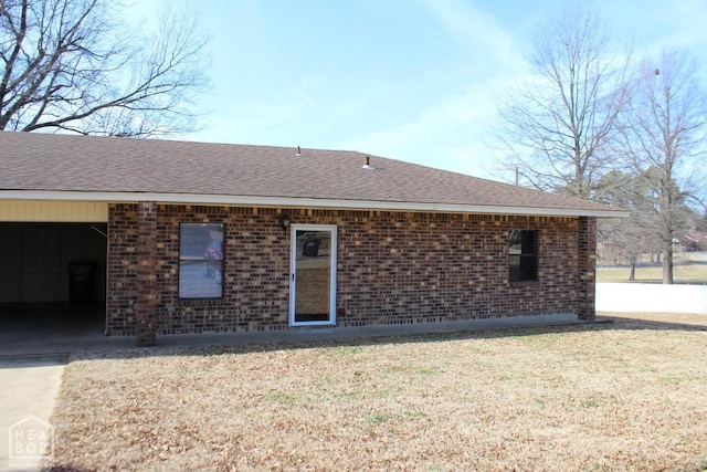 1805 Covey Dr, Jonesboro, AR 72404 - back of property featuring brick siding, a shingled roof, and a yard