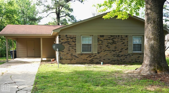 1805 Covey Dr, Jonesboro, AR 72404 - view of front of property with brick siding, a carport, concrete driveway, and a front yard