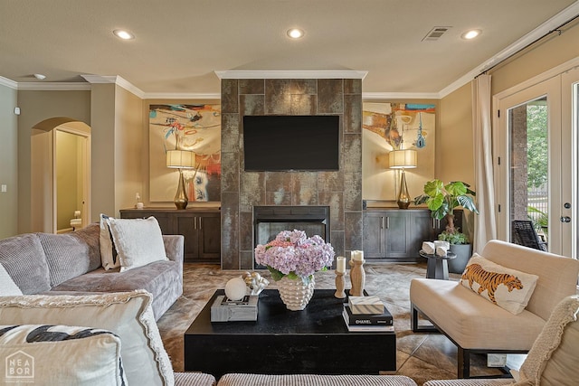 living room featuring crown molding, arched walkways, visible vents, and recessed lighting