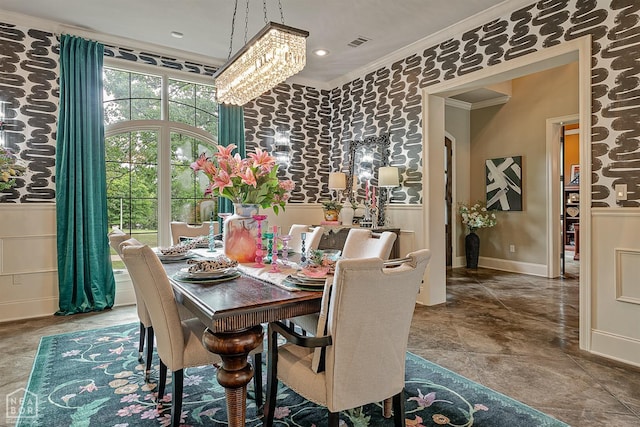 dining room featuring ornamental molding, stone finish floor, visible vents, an inviting chandelier, and baseboards