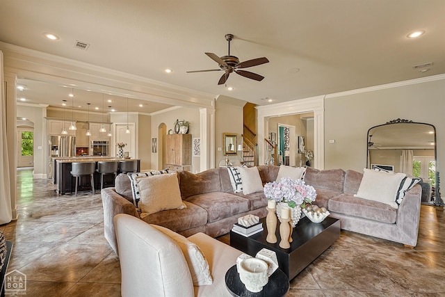 living area featuring a ceiling fan, crown molding, stairway, arched walkways, and recessed lighting