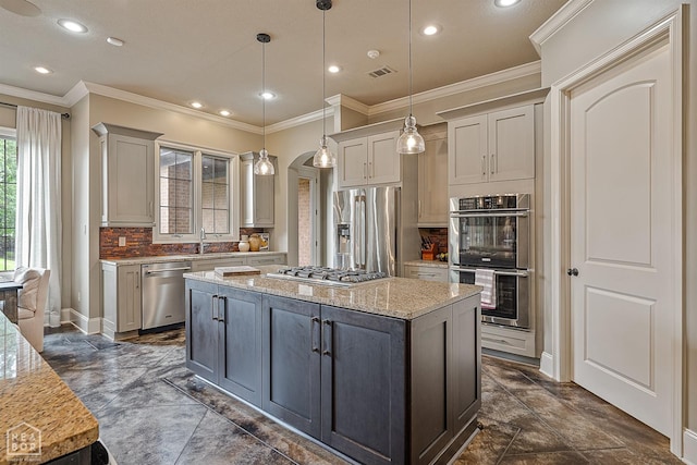 kitchen featuring crown molding, stainless steel appliances, tasteful backsplash, and recessed lighting