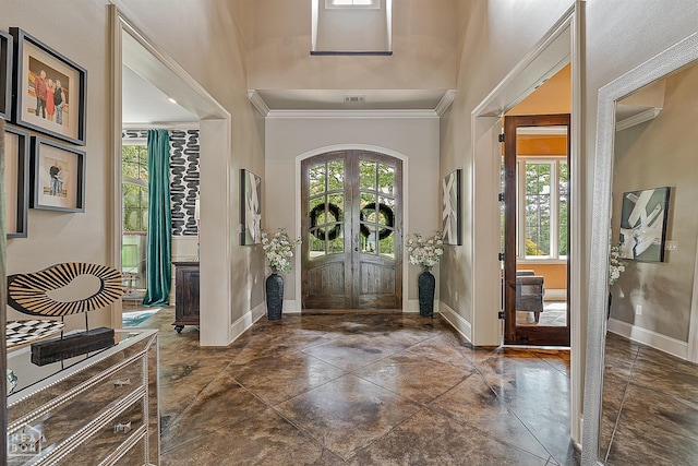 entryway with crown molding, baseboards, french doors, and a healthy amount of sunlight