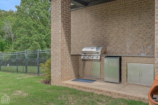 view of patio / terrace featuring a sink, area for grilling, grilling area, and fence