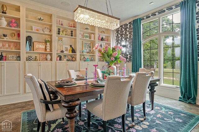dining area featuring an inviting chandelier, built in features, and a healthy amount of sunlight