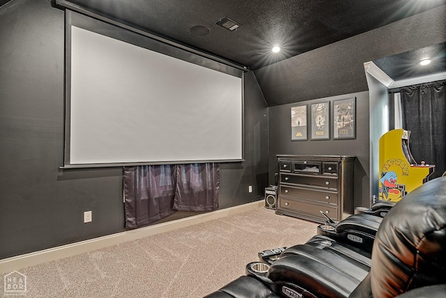 carpeted cinema with vaulted ceiling, a textured ceiling, baseboards, and visible vents
