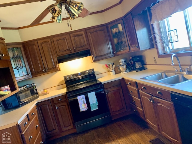 kitchen with under cabinet range hood, light countertops, black appliances, ceiling fan, and a sink
