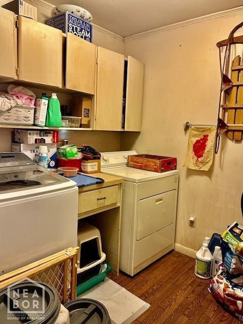laundry area with crown molding, baseboards, dark wood-style flooring, separate washer and dryer, and cabinet space