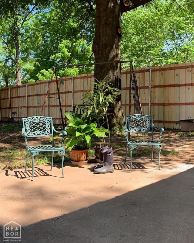 view of patio / terrace featuring fence