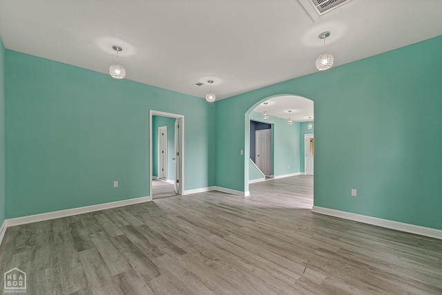 615 W Main St W, Trumann, AR 72472 - spare room with arched walkways, wood finished floors, and baseboards