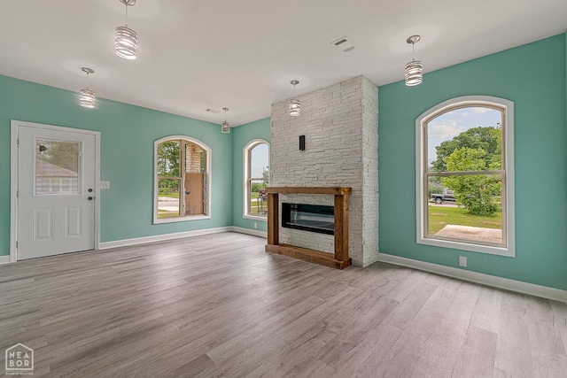 615 W Main St W, Trumann, AR 72472 - unfurnished living room with wood finished floors, a fireplace, and baseboards