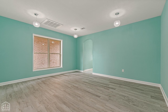 615 W Main St W, Trumann, AR 72472 - empty room featuring wood finished floors, baseboards, and arched walkways