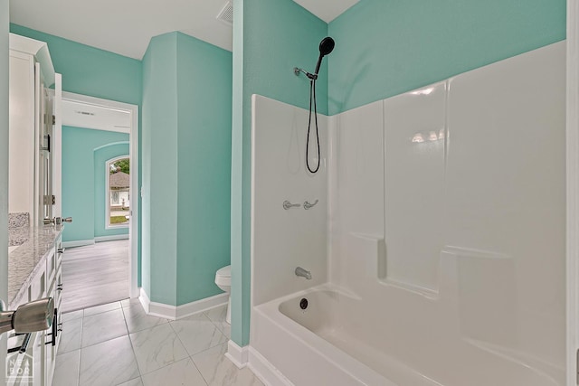 615 W Main St W, Trumann, AR 72472 - bathroom featuring toilet, baseboards, marble look tile flooring, bathtub / shower combination, and vanity