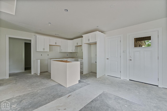 305 Carol Ave, Monette, AR 72447 - kitchen with a kitchen island and white cabinetry