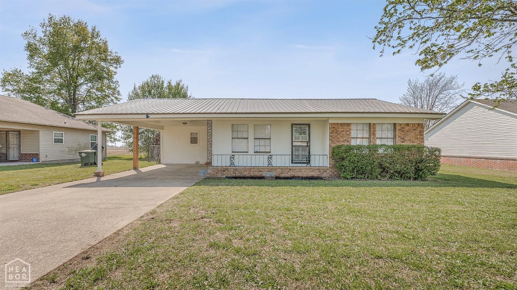 3405 Debra Ln, Blytheville, AR 72315 - view of front of property featuring an attached carport, a front yard, driveway, and covered porch