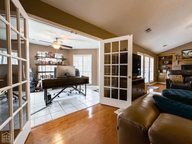 living area featuring french doors, an office area, wood finished floors, a ceiling fan, and plenty of natural light