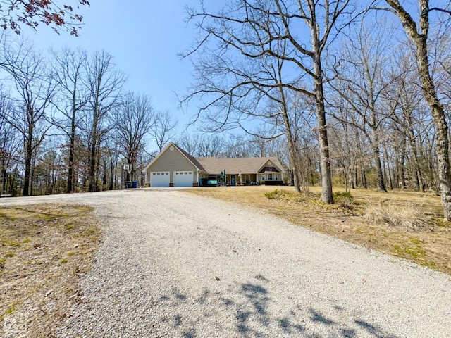 single story home featuring an attached garage and driveway