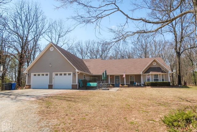 single story home with an attached garage, concrete driveway, and a front yard