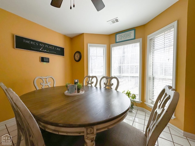 dining area with light tile patterned floors, baseboards, and a ceiling fan