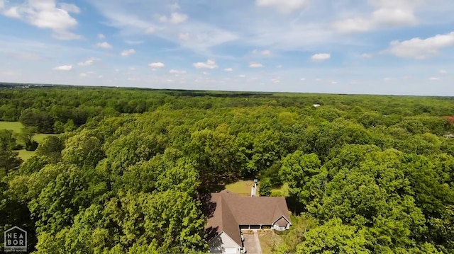 view of subject property featuring a forest