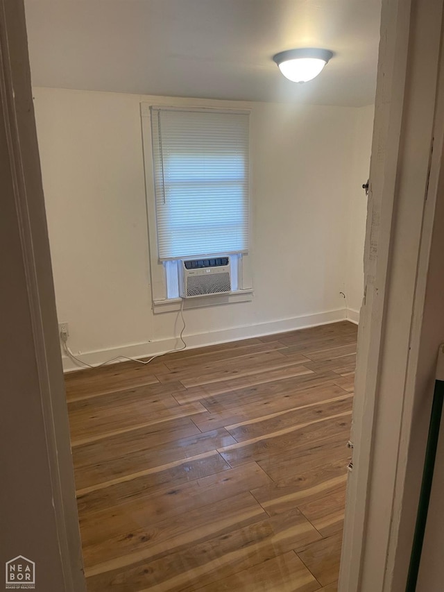 1007 Warren St, Jonesboro, AR 72401 - unfurnished room with baseboards, cooling unit, and hardwood / wood-style flooring