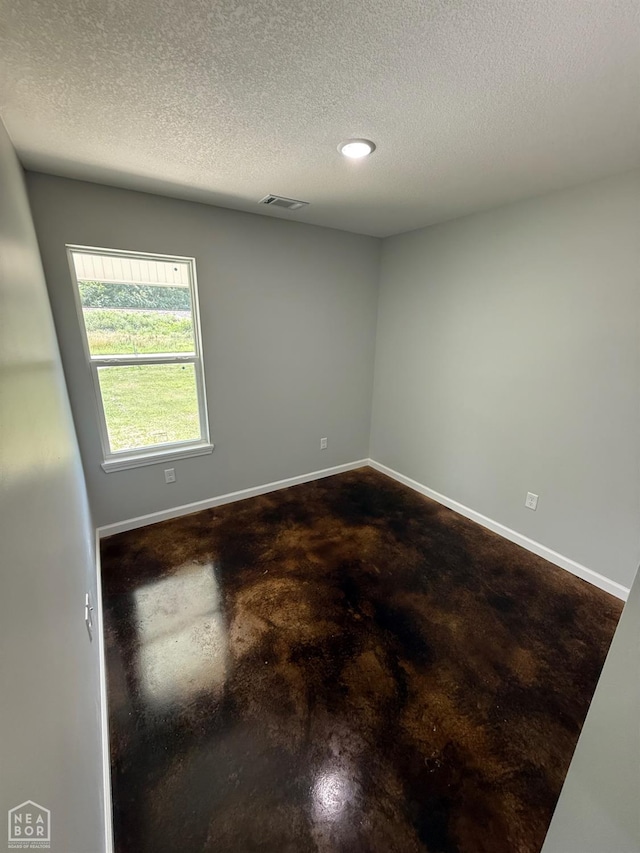 704 N Ozark St, Trumann, AR 72472 - spare room featuring a textured ceiling, finished concrete flooring, and recessed lighting