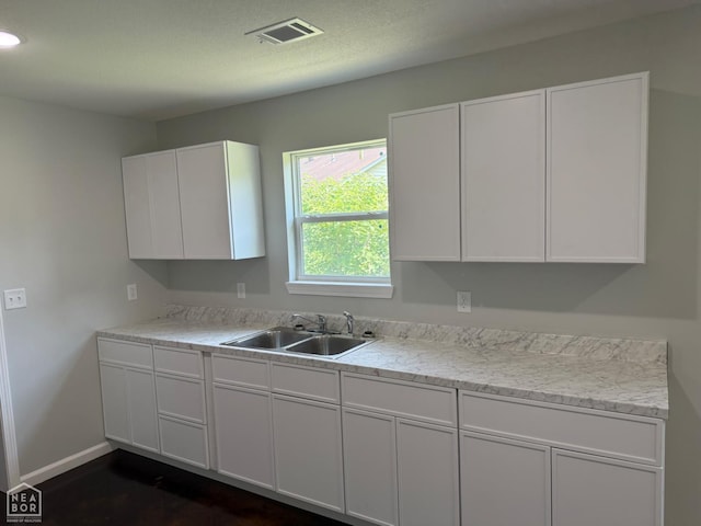 704 N Ozark St, Trumann, AR 72472 - kitchen featuring white cabinetry, light countertops, and recessed lighting