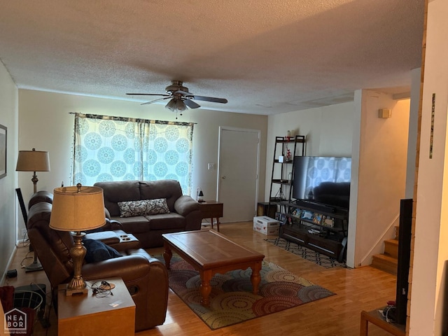 1304 Dana Debbie St, Jonesboro, AR 72405 - living room with wood finished floors, ceiling fan, a textured ceiling, and stairway