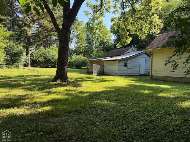 1304 Dana Debbie St, Jonesboro, AR 72405 - view of green lawn with an outbuilding
