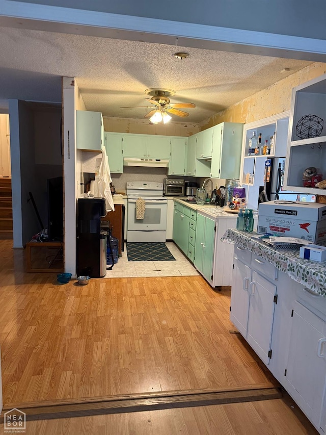 1304 Dana Debbie St, Jonesboro, AR 72405 - kitchen with white electric range, green cabinets, light wood-style floors, a ceiling fan, and a textured ceiling