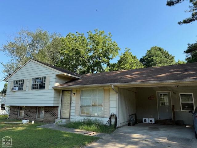1304 Dana Debbie St, Jonesboro, AR 72405 - tri-level home with an attached carport, driveway, a front yard, and entry steps