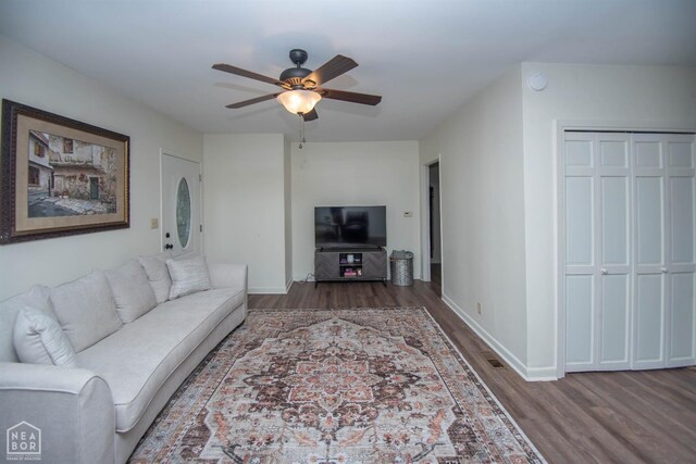 1123 Olive St, Jonesboro, AR 72401 - living room featuring wood finished floors, a ceiling fan, and baseboards
