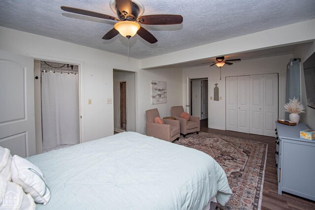 1123 Olive St, Jonesboro, AR 72401 - bedroom featuring dark wood-type flooring, a textured ceiling, and ceiling fan